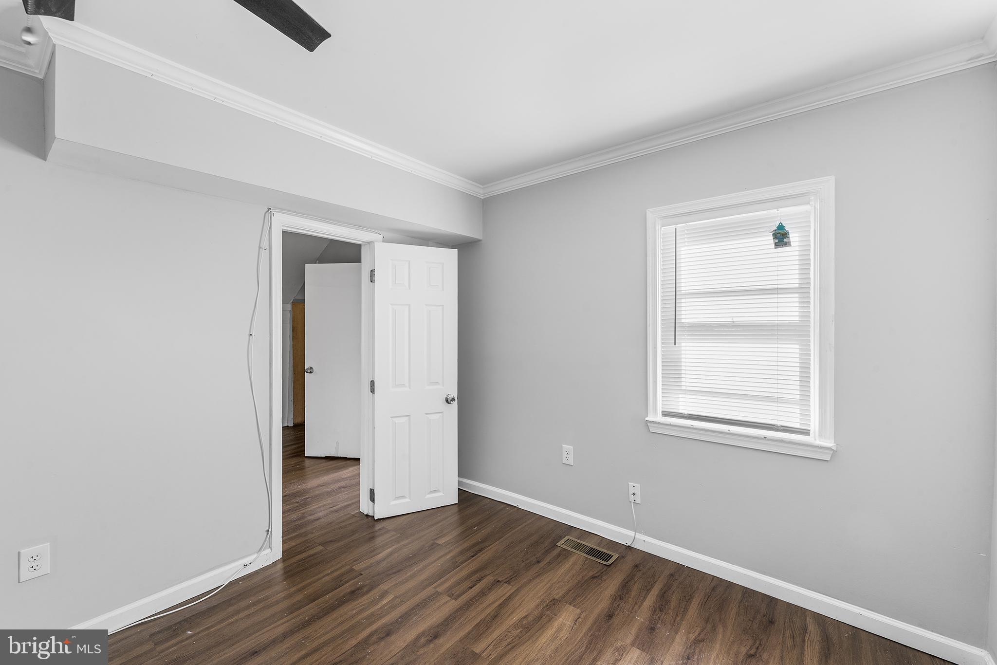 2 Fusting Avenue Baltimore, MD 21228 - Photo 13 of 26 an empty room with wooden floor and windows