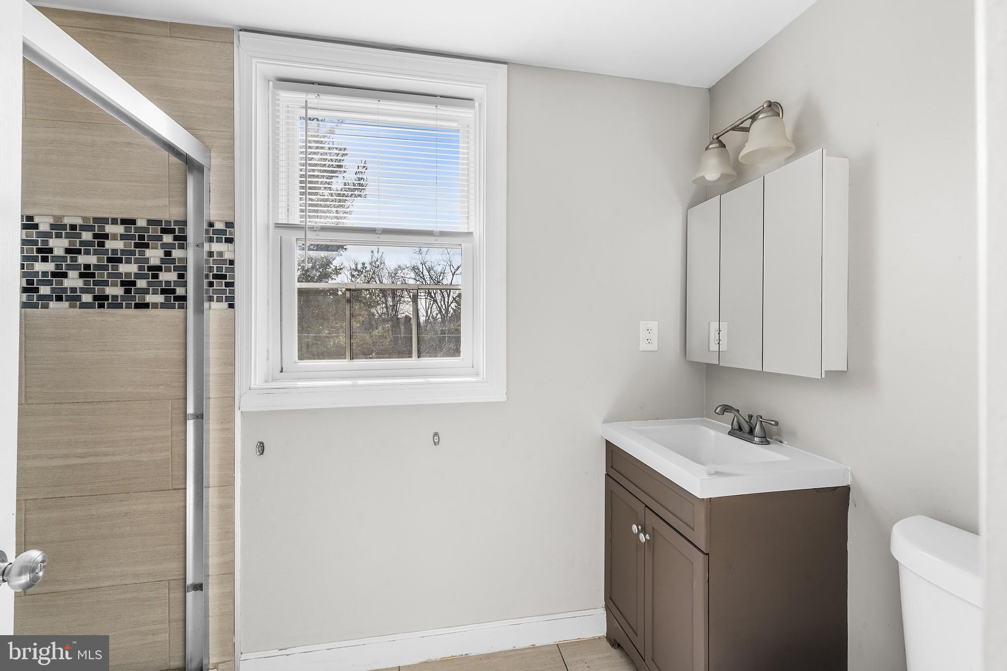 2 Fusting Avenue Baltimore, MD 21228 - Photo 14 of 26 a bathroom with a sink and a mirror