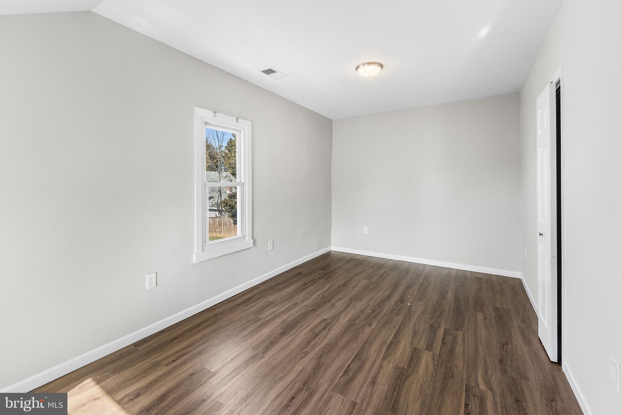 2 Fusting Avenue Baltimore, MD 21228 - Photo 15 of 26 an empty room with wooden floor and windows
