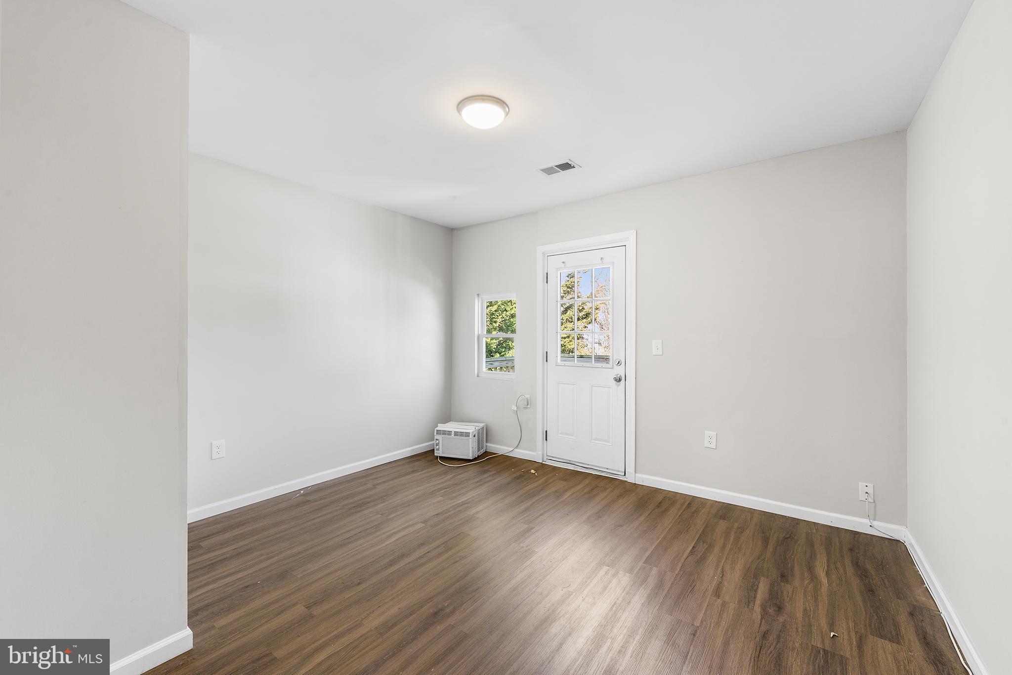 2 Fusting Avenue Baltimore, MD 21228 - Photo 17 of 26 an empty room with wooden floor and windows