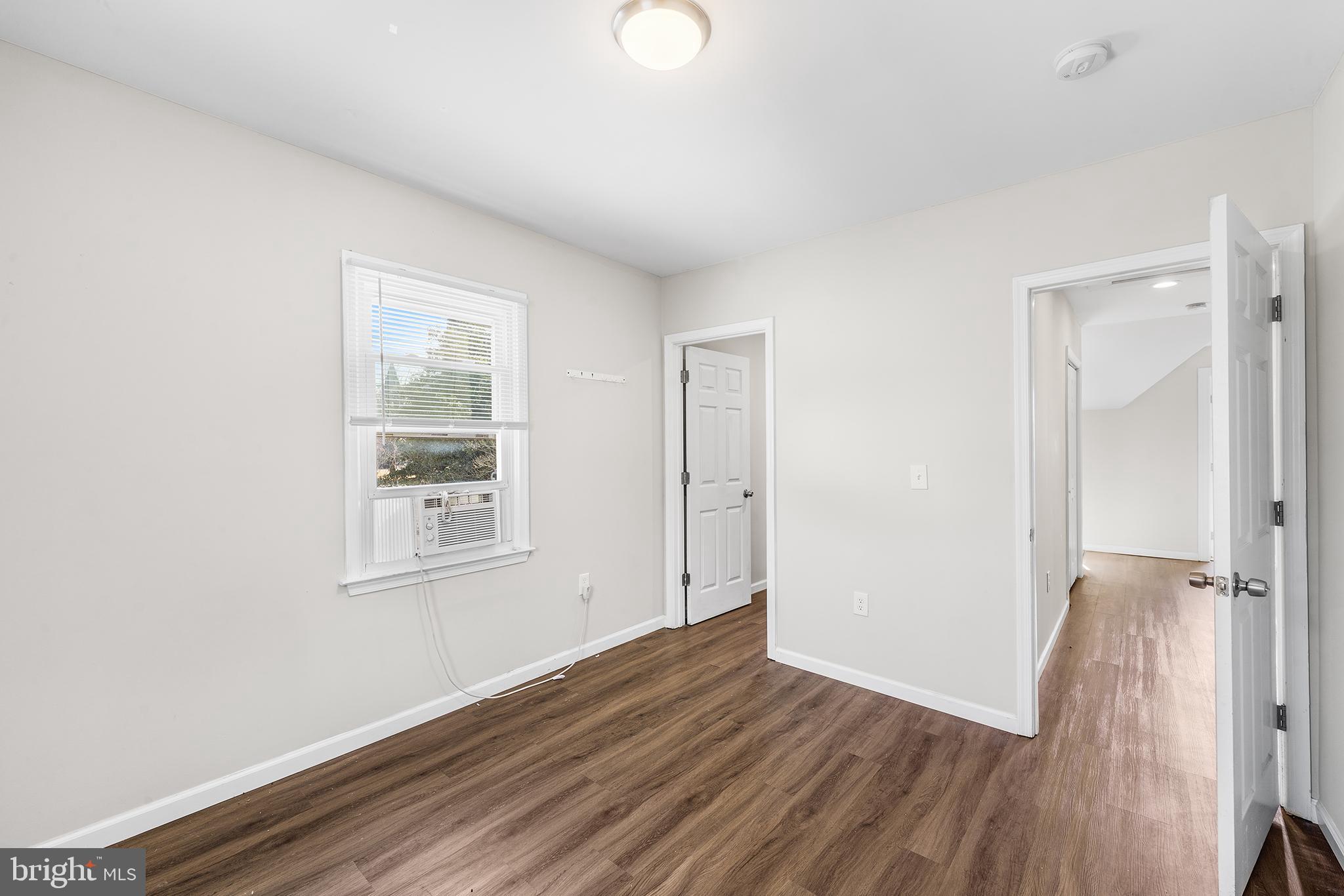2 Fusting Avenue Baltimore, MD 21228 - Photo 22 of 26 an empty room with wooden floor and windows