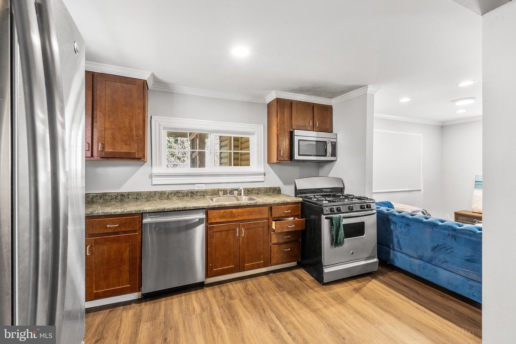 2 Fusting Avenue Baltimore, MD 21228 - Photo 7 of 26 a kitchen with stainless steel appliances granite countertop a stove top oven a sink and dishwasher