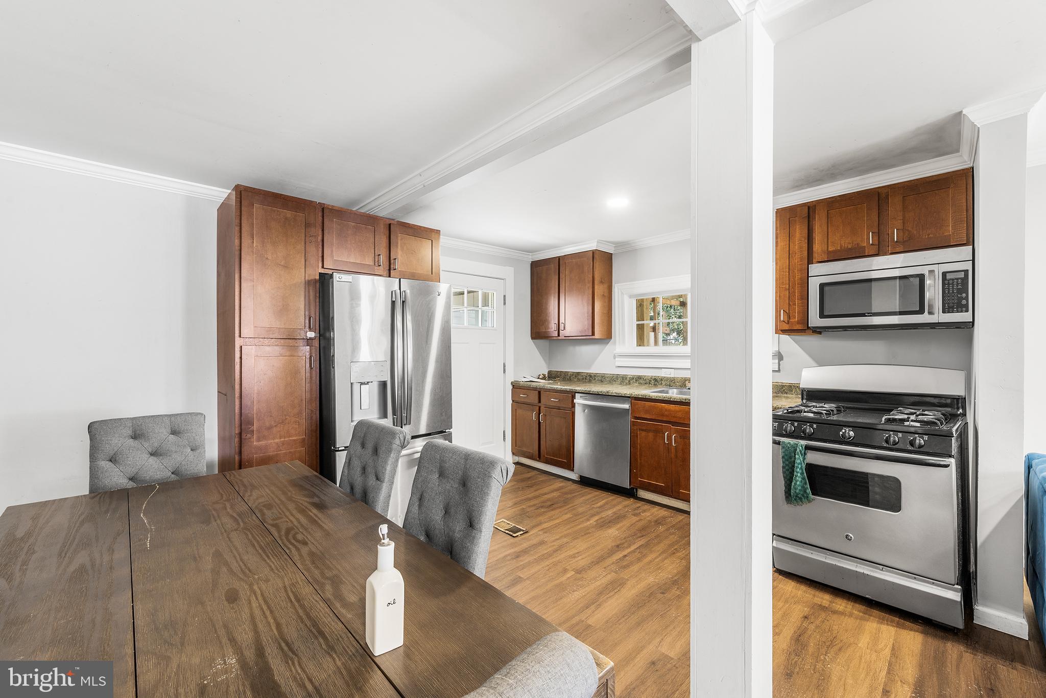 2 Fusting Avenue Baltimore, MD 21228 - Photo 8 of 26 a kitchen with granite countertop a refrigerator stove and oven