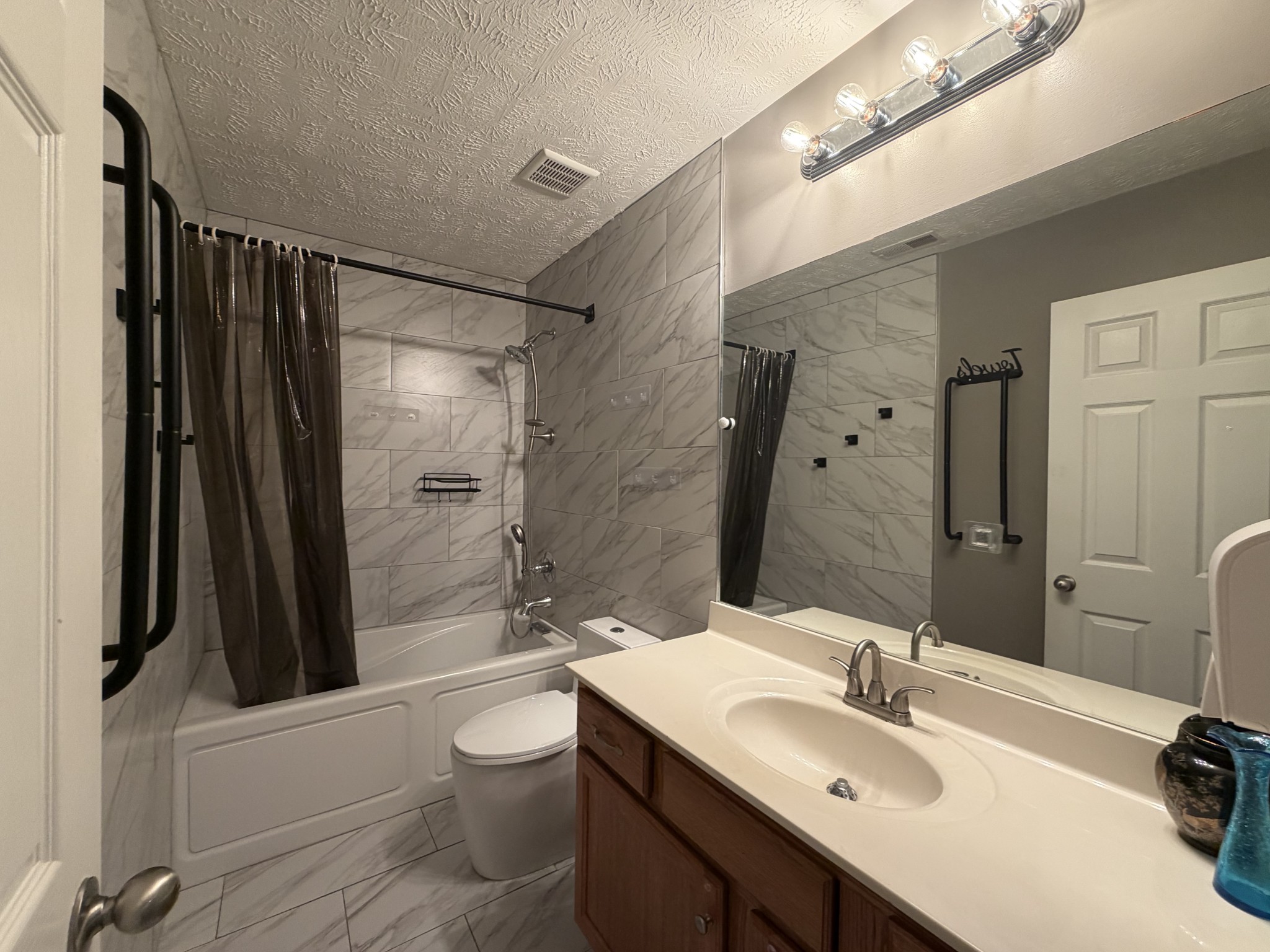 2938 Ridgewood Drive Christiana, TN 37037 - Photo 43 of 66 a bathroom with a sink a toilet a mirror and shower