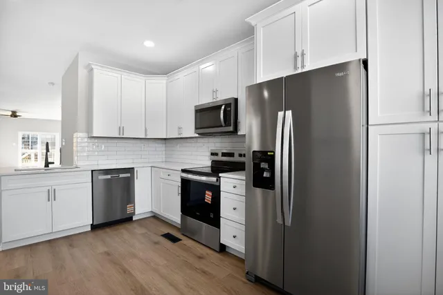 a kitchen with stainless steel appliances a refrigerator sink and stove
