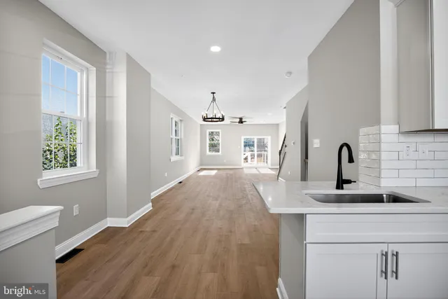 a hallway with a sink and a window