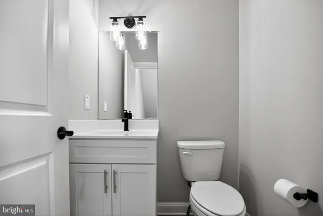 a bathroom with a toilet sink and mirror