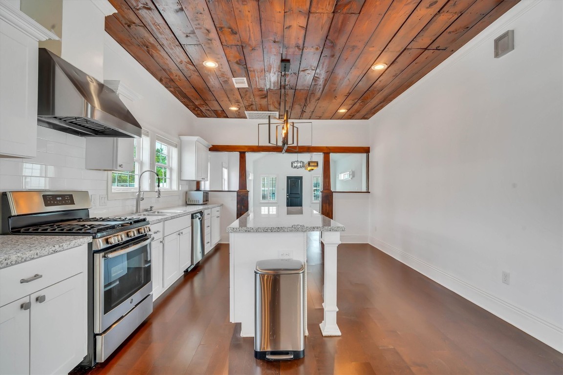 2405 Keene Street Houston, TX 77009 - Photo 11 of 45 a kitchen with stainless steel appliances granite countertop a stove a sink and a refrigerator
