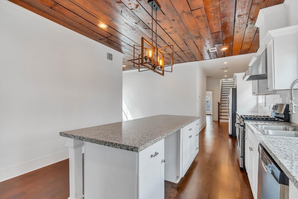 2405 Keene Street Houston, TX 77009 - Photo 12 of 45 a kitchen with stainless steel appliances granite countertop a sink stove and refrigerator