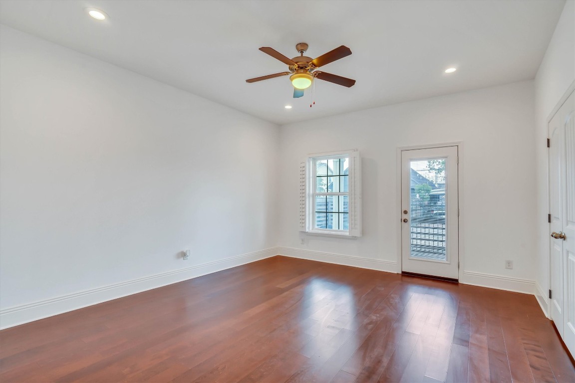 2405 Keene Street Houston, TX 77009 - Photo 15 of 45 an empty room with wooden floor fan and windows