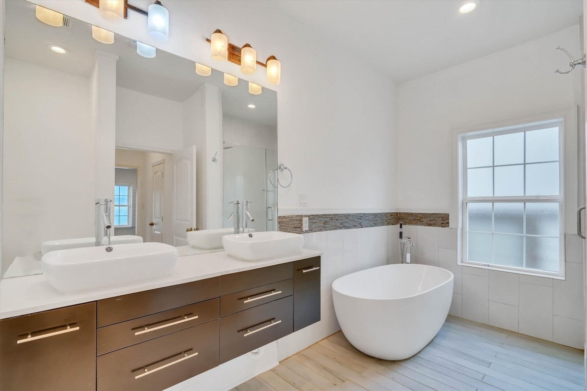 2405 Keene Street Houston, TX 77009 - Photo 20 of 45 a bathroom with a double vanity sink mirror and bathtub