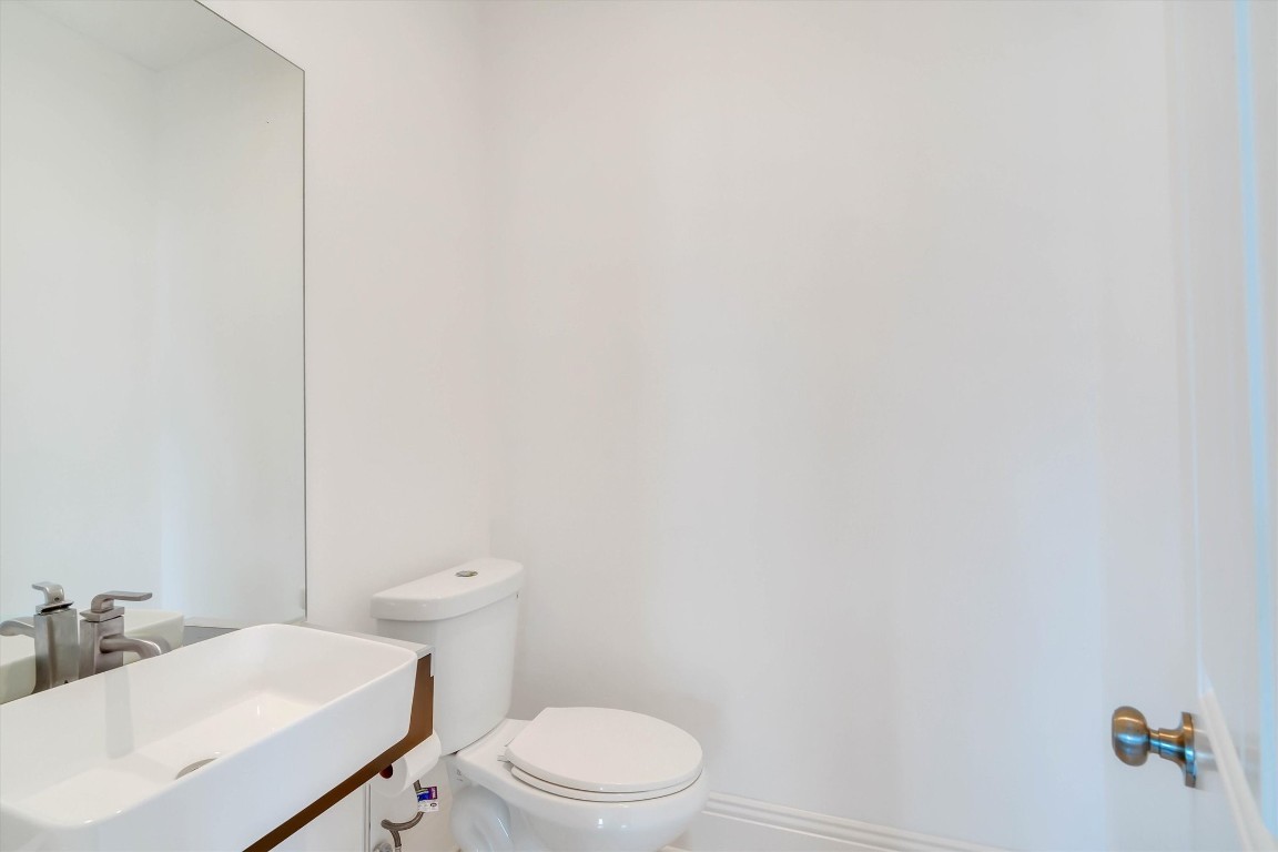 2405 Keene Street Houston, TX 77009 - Photo 6 of 45 a white toilet sitting next to a white sink