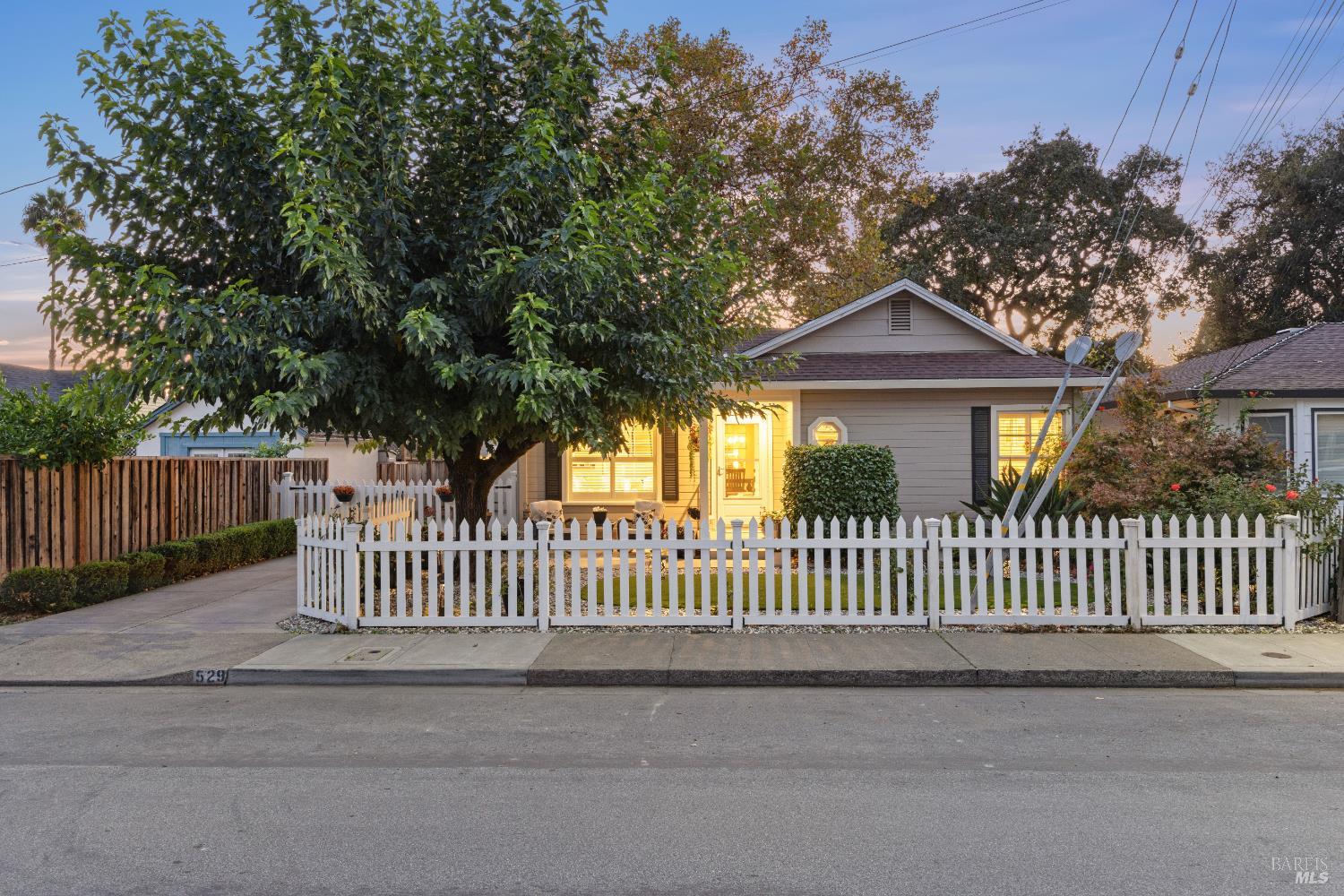 a view of a house with a wooden fence