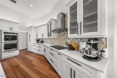 a kitchen with stainless steel appliances granite countertop a stove and a sink