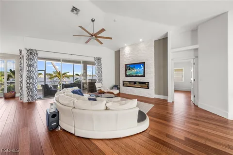 a living room with fireplace furniture and a wooden floor