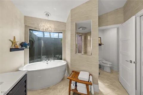 a bathroom with a bathtub shower sink and toilet