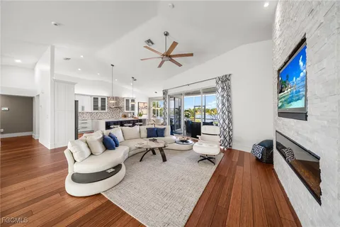 a living room with furniture fireplace and wooden floor