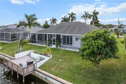 a view of a house with a backyard and a patio