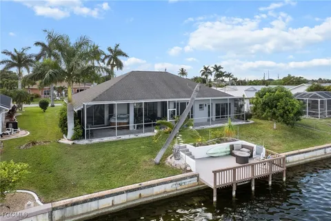 a view of a house with backyard and sitting area