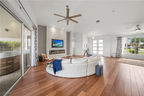 a living room with furniture and a wooden floor