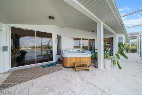 a bedroom with furniture and a large window