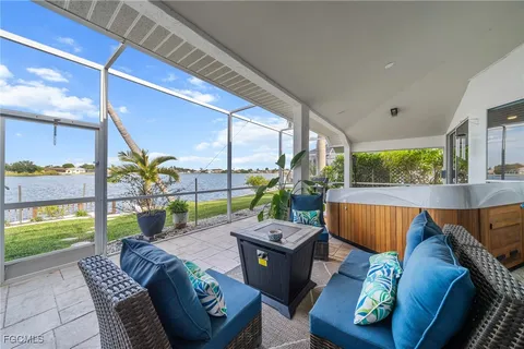 a living room with couch and a floor to ceiling window