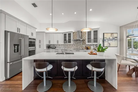 a kitchen with cabinets and stainless steel appliances