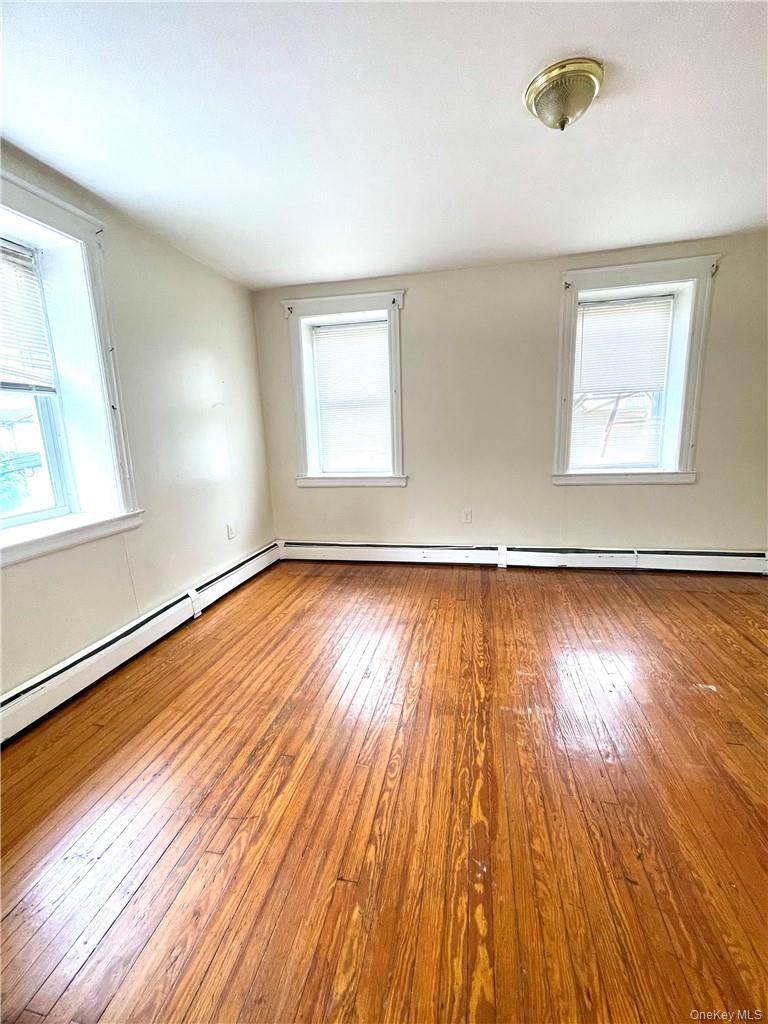 27 Fox Island Road Port Chester, NY 10573 - Photo 15 of 29 an empty room with wooden floor and windows