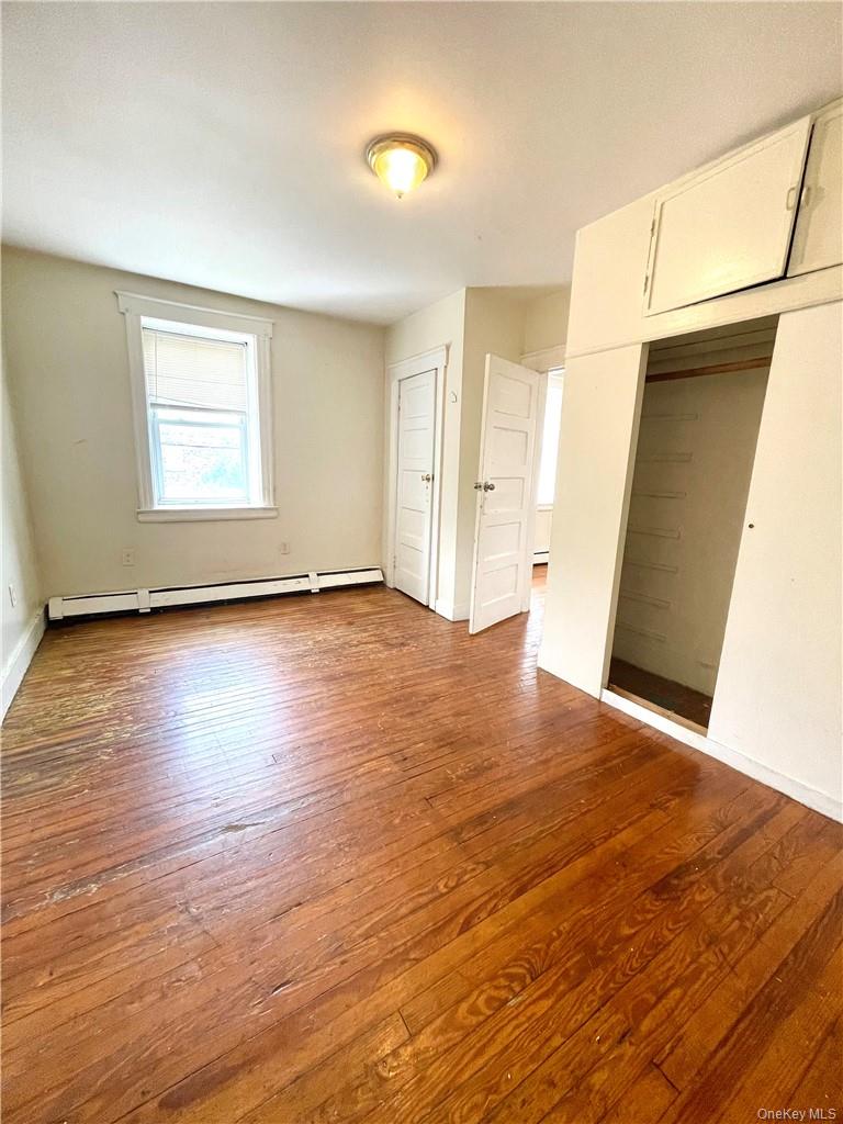 27 Fox Island Road Port Chester, NY 10573 - Photo 16 of 29 a view of an empty room with wooden floor and a window