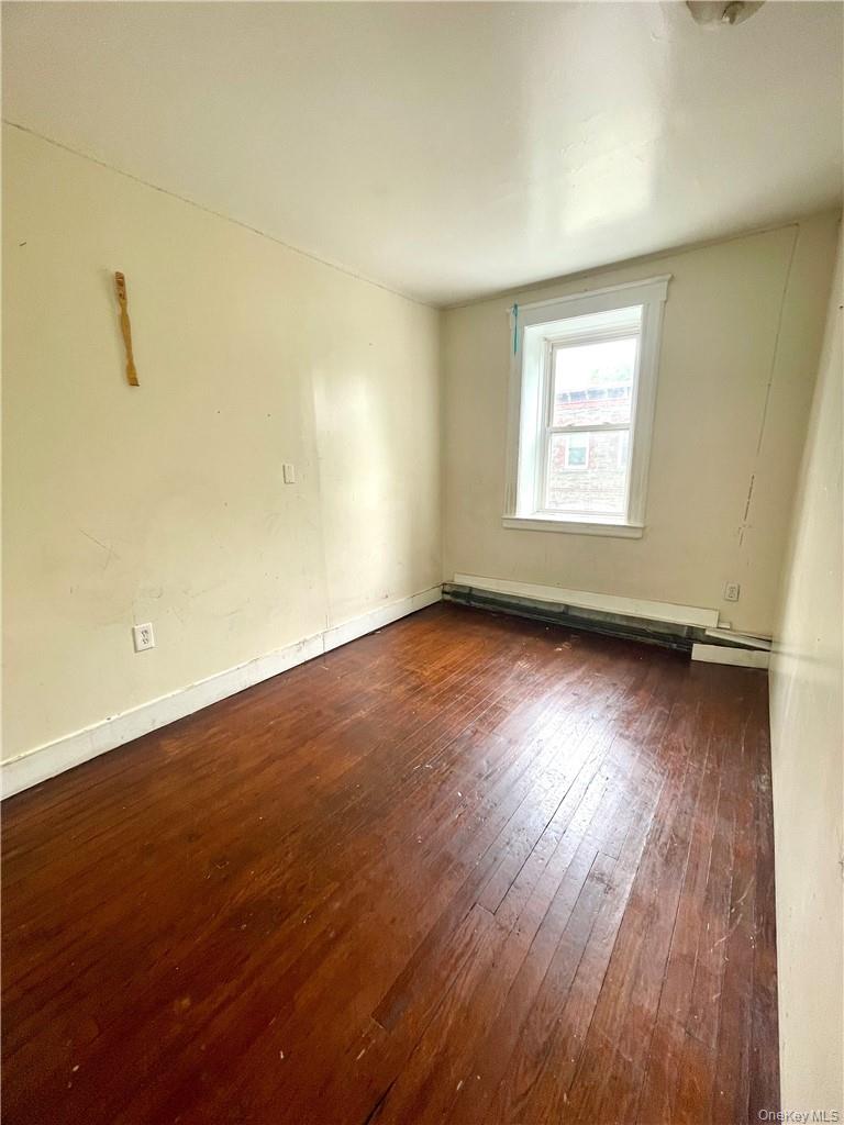 27 Fox Island Road Port Chester, NY 10573 - Photo 20 of 29 an empty room with wooden floor and windows