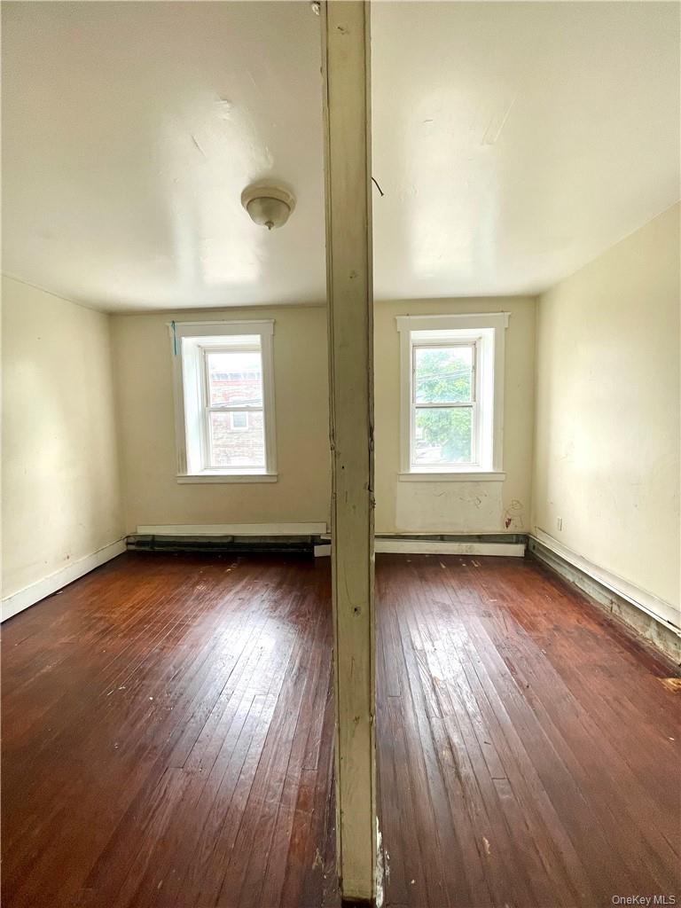 27 Fox Island Road Port Chester, NY 10573 - Photo 22 of 29 an empty room with wooden floor and windows