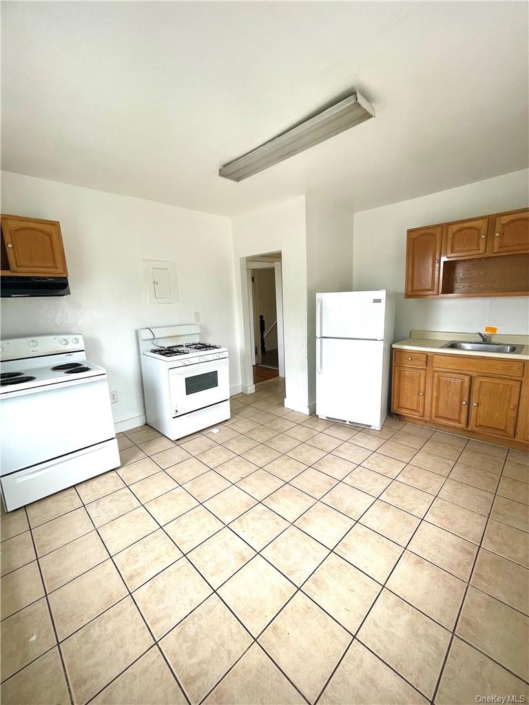27 Fox Island Road Port Chester, NY 10573 - Photo 4 of 29 a kitchen with a cabinets and a stove top oven
