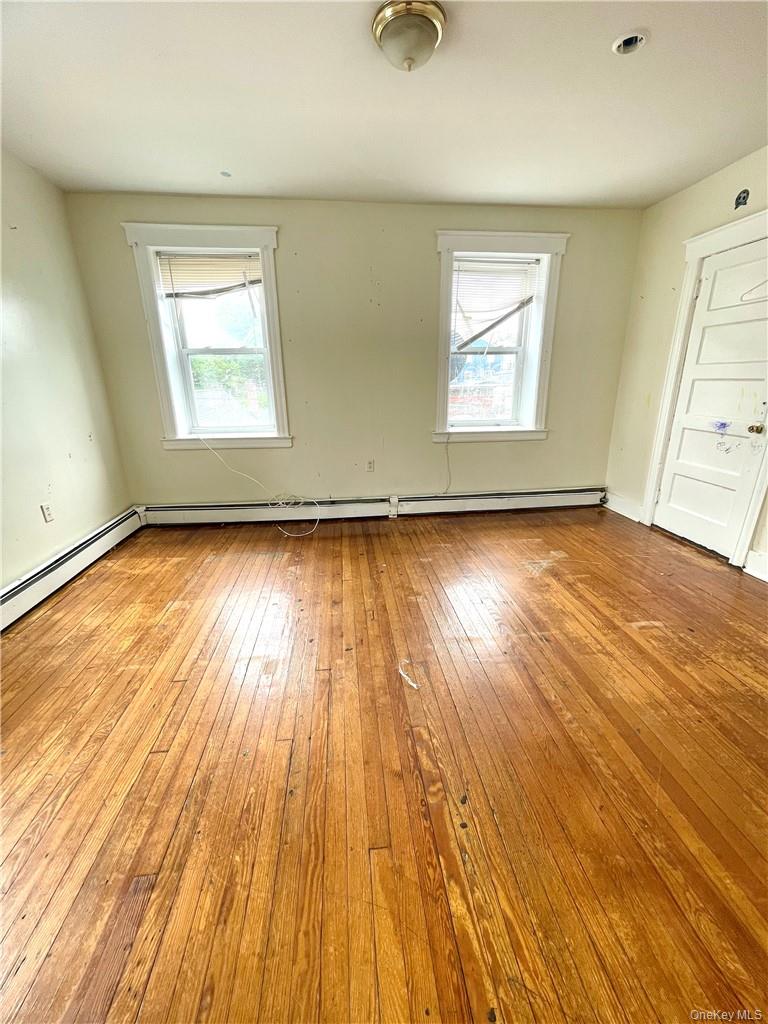27 Fox Island Road Port Chester, NY 10573 - Photo 5 of 29 an empty room with wooden floor and windows