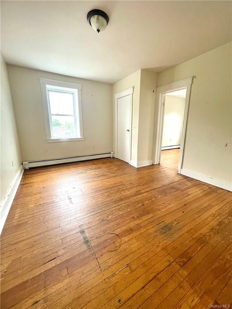 27 Fox Island Road Port Chester, NY 10573 - Photo 6 of 29 an empty room with wooden floor and windows