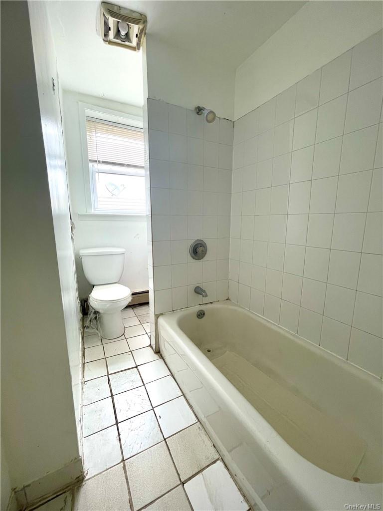 27 Fox Island Road Port Chester, NY 10573 - Photo 7 of 29 a bathroom with a bathtub a toilet and a shower