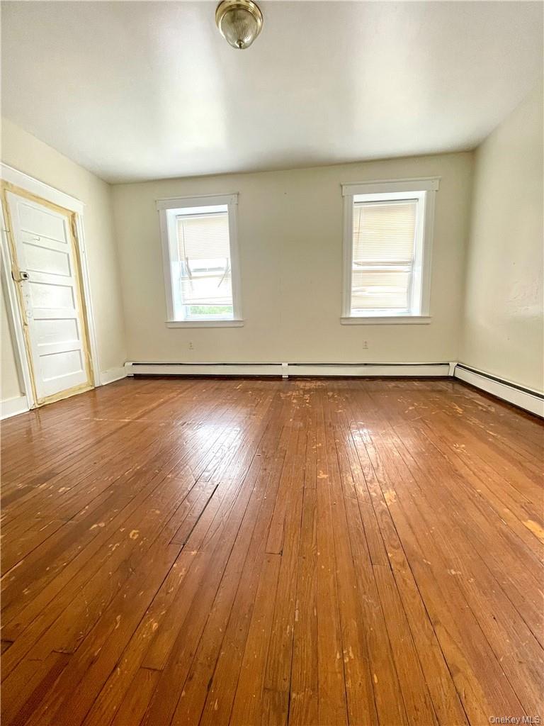 27 Fox Island Road Port Chester, NY 10573 - Photo 9 of 29 an empty room with wooden floor and windows