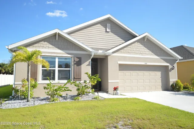 a front view of a house with a yard and porch