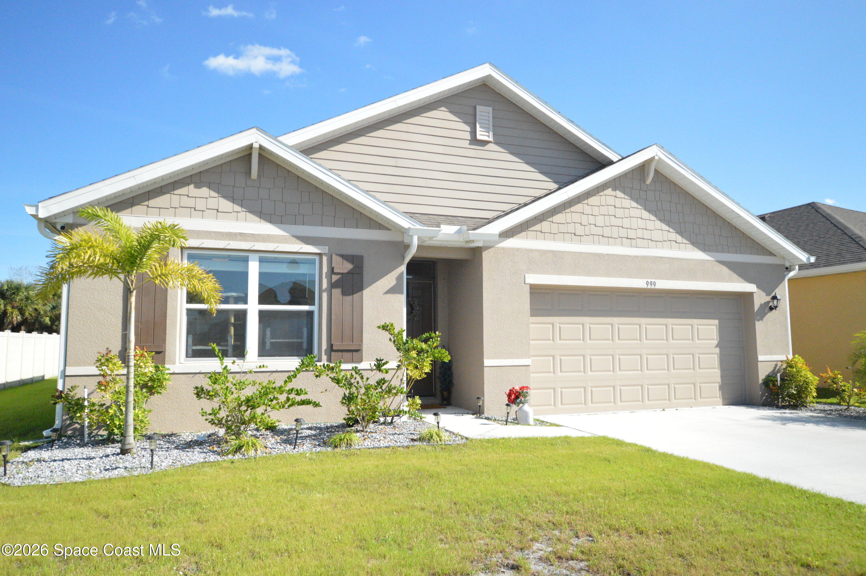 a front view of a house with a yard and porch
