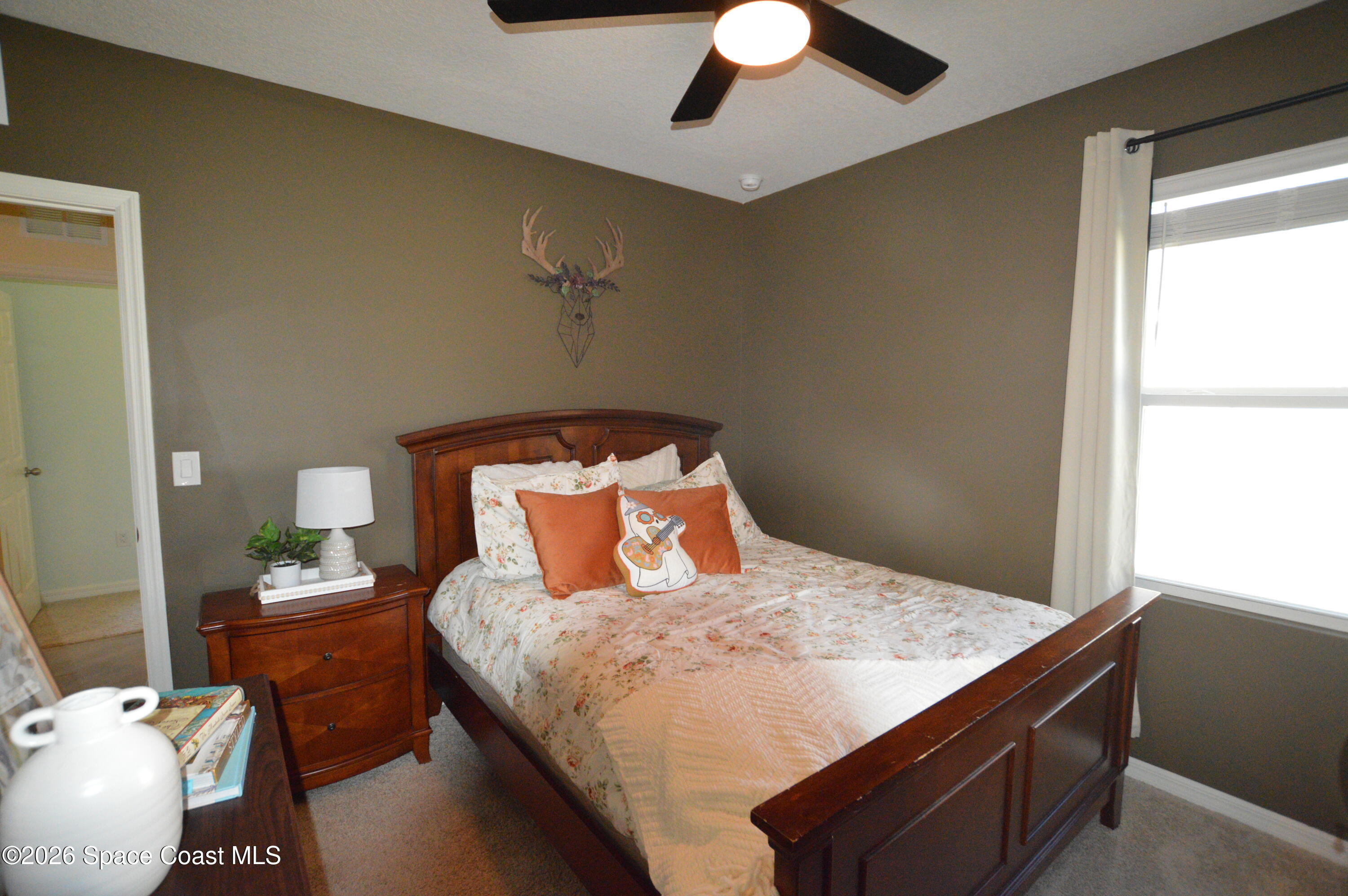 999 Trinity Street Rockledge, FL 32955 - Photo 14 of 20 a bedroom with a bed and window