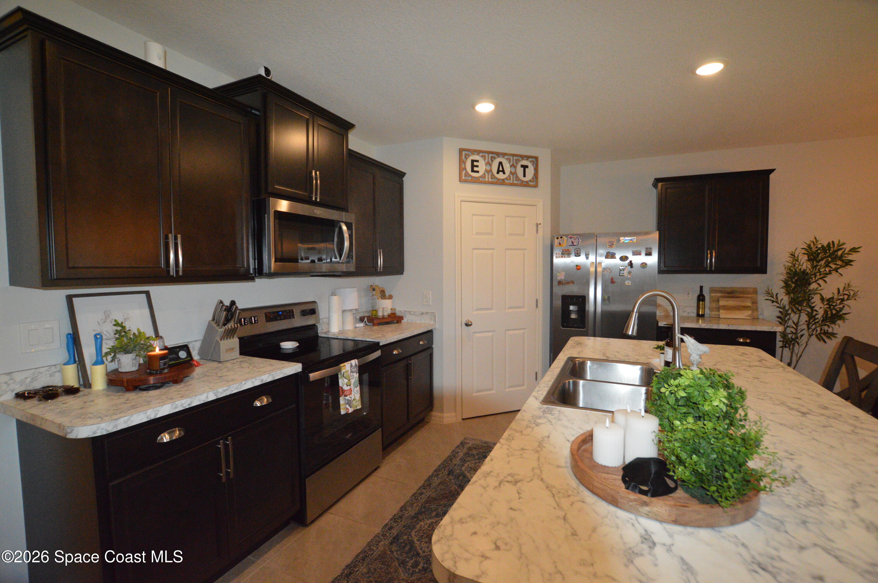 999 Trinity Street Rockledge, FL 32955 - Photo 5 of 20 a kitchen with cabinets a sink and a stove