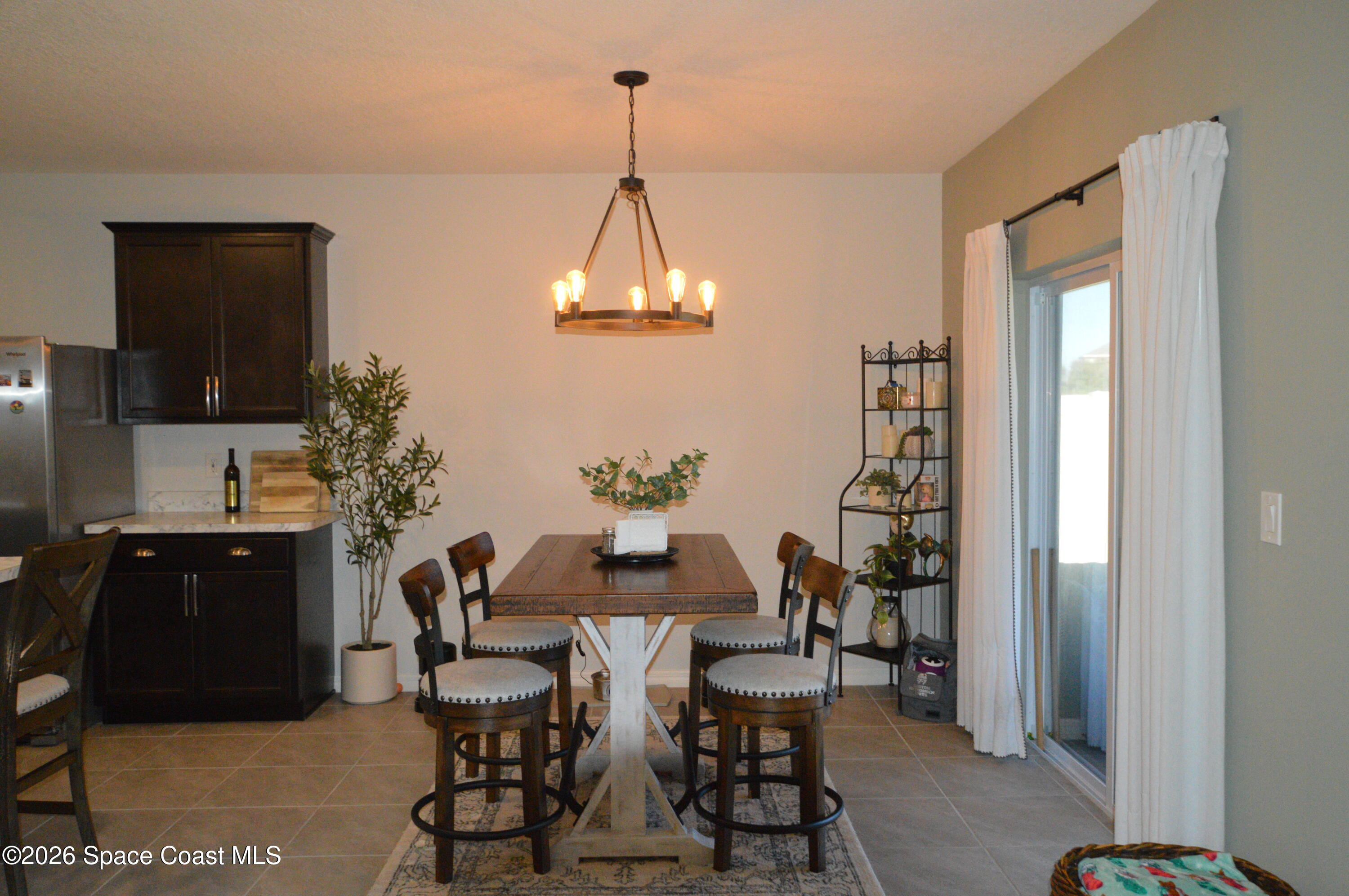 999 Trinity Street Rockledge, FL 32955 - Photo 8 of 20 a dining room with furniture and window
