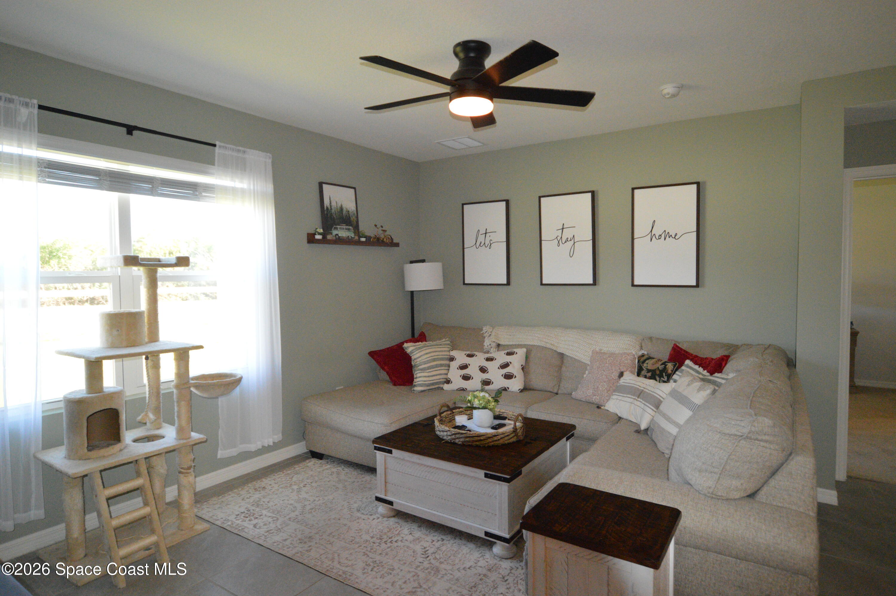 999 Trinity Street Rockledge, FL 32955 - Photo 9 of 20 a living room with furniture and a large window