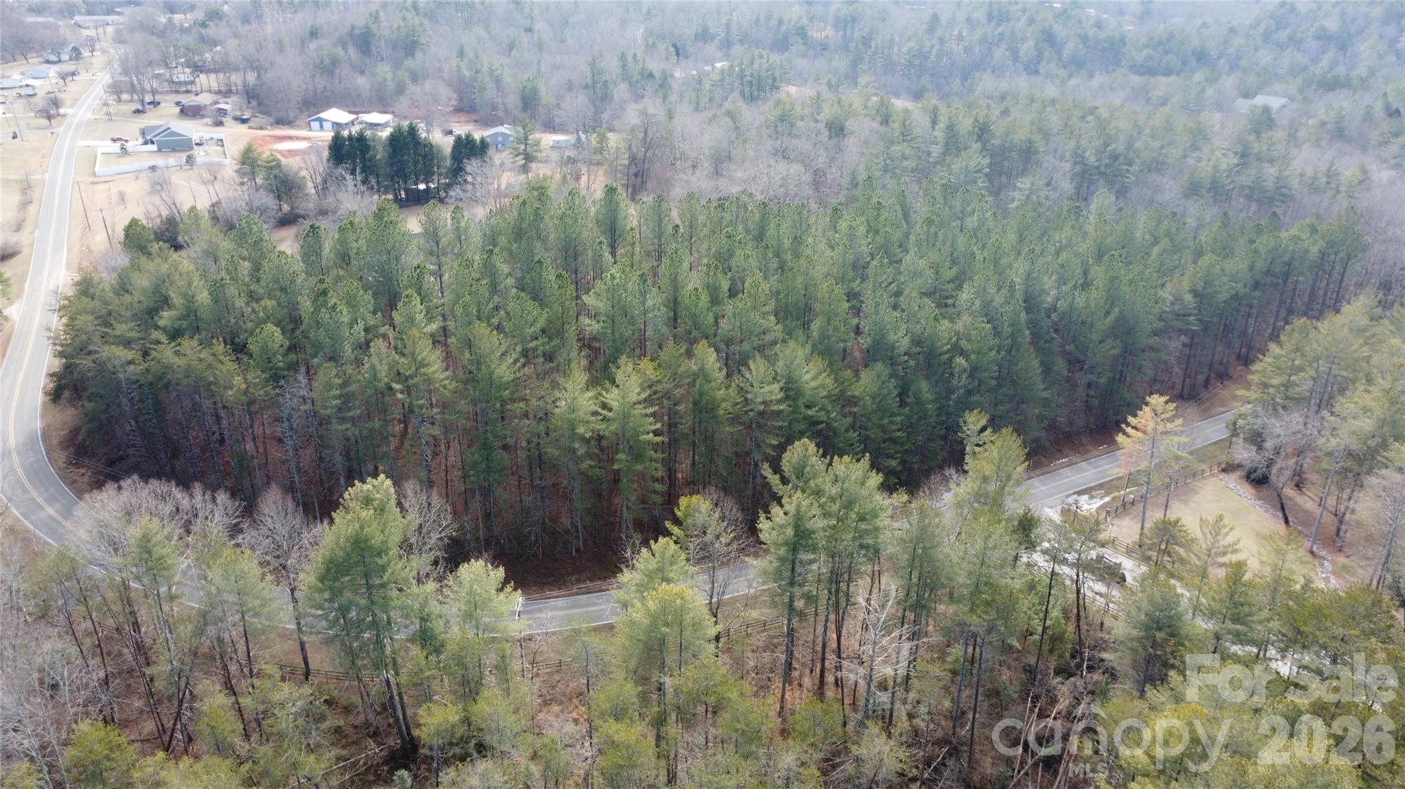 4650 John Berry Road Valdese, NC 28690 - Photo 2 of 12 a backyard of a house with lots of green space and trees all around