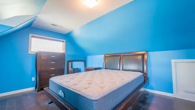 a bedroom with a large bed and a dresser