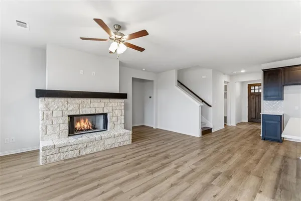 an empty room with a window and a ceiling fan