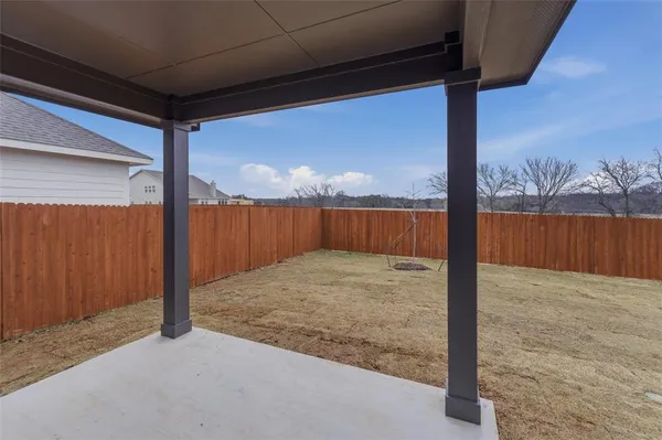 a view of a house with a yard and seating area