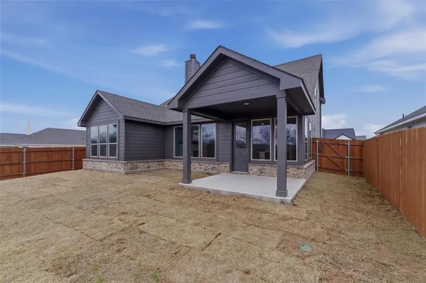 a view of a house with wooden fence