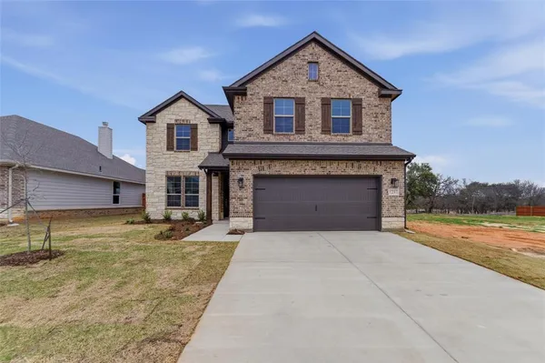 a front view of a house with a yard and garage