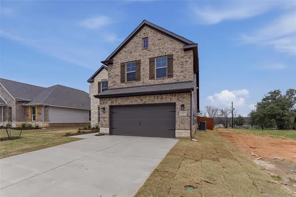 a view of a house with a yard and garage