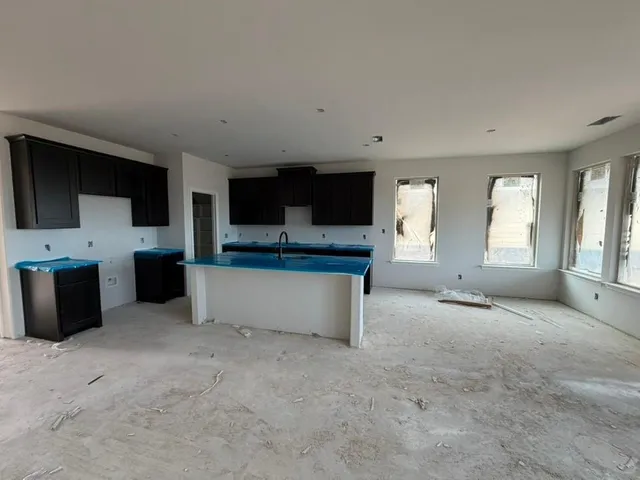 a view of a livingroom with an empty space and a window